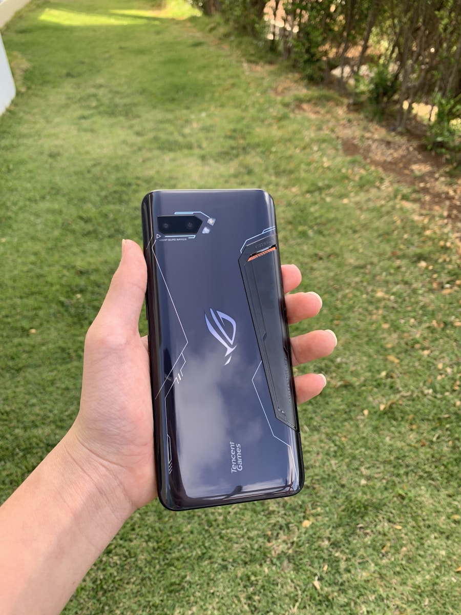 A mobile gaming phone held outdoors