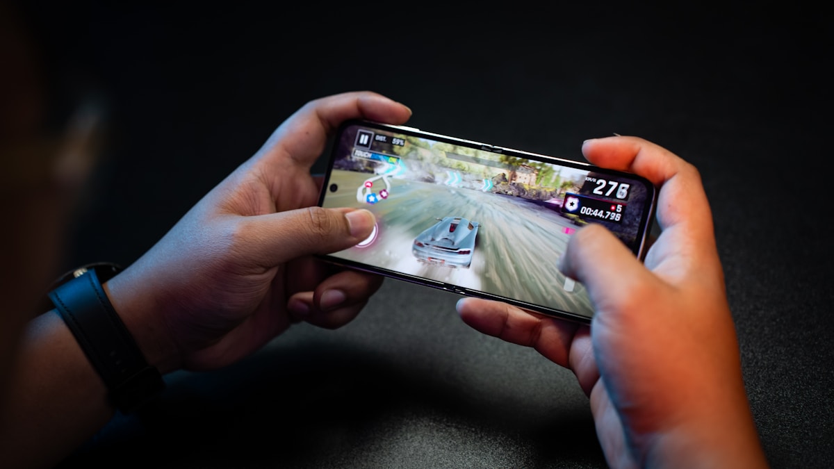 A player enjoying a racing game on a smartphone